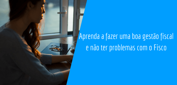 Mulher sentada com seu notebook pesquisando sobre gestão fiscal com uma xícara, um óculos e um caderno ao seu lado.